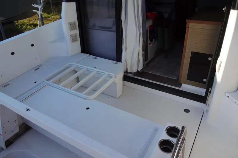 Slide: The Image of 2022 Jeanneau Merry Fisher 895 Offshore boat interior with seating and storage. - 28