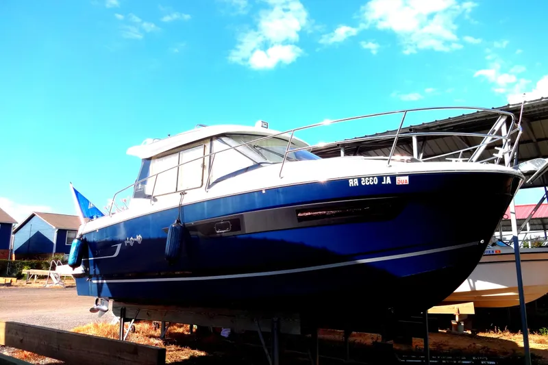 Slide: The Image of 2022 Jeanneau Merry Fisher 895 Offshore boat on display under clear blue sky. - 3