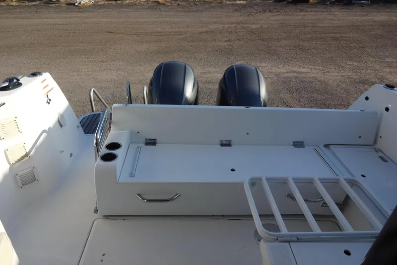 Slide: The Image of 2022 Jeanneau Merry Fisher 895 Offshore boat deck with twin engines and seating area. - 30