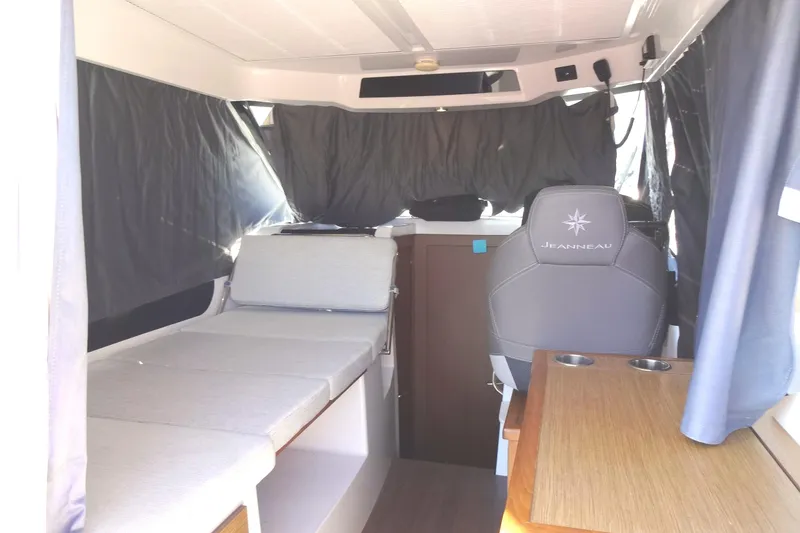 Slide: The Image of Interior of 2022 Jeanneau Merry Fisher 895 Offshore, featuring seating and helm area. - 35