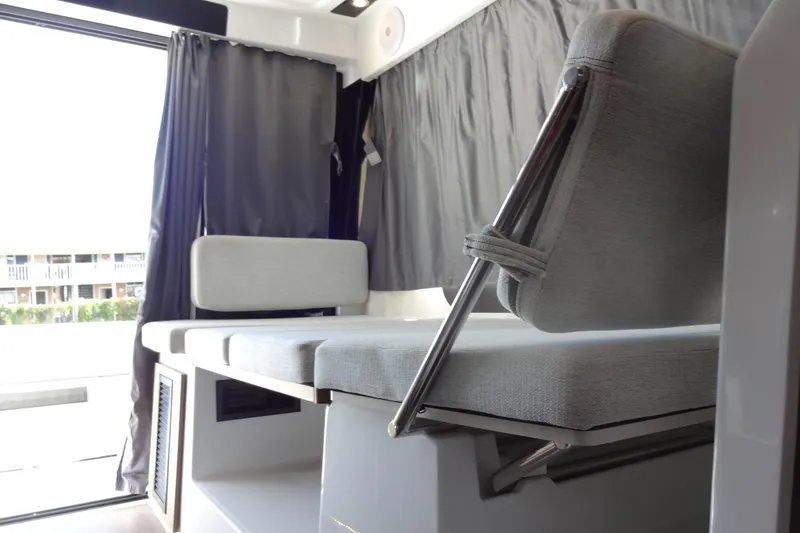 Slide: The Image of Interior seating of 2022 Jeanneau Merry Fisher 895 Offshore boat with gray upholstery. - 42