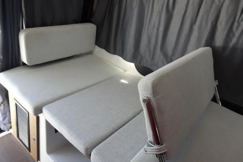 Slide: The Image of Interior seating of 2022 Jeanneau Merry Fisher 895 Offshore boat, featuring gray cushions. - 46
