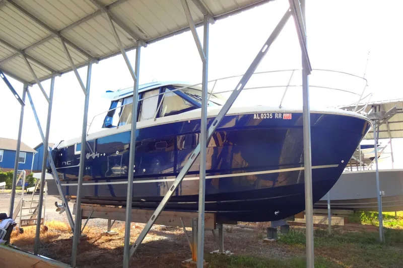 Slide: The Image of 2022 Jeanneau Merry Fisher 895 Offshore boat in dry dock under shelter. - 5