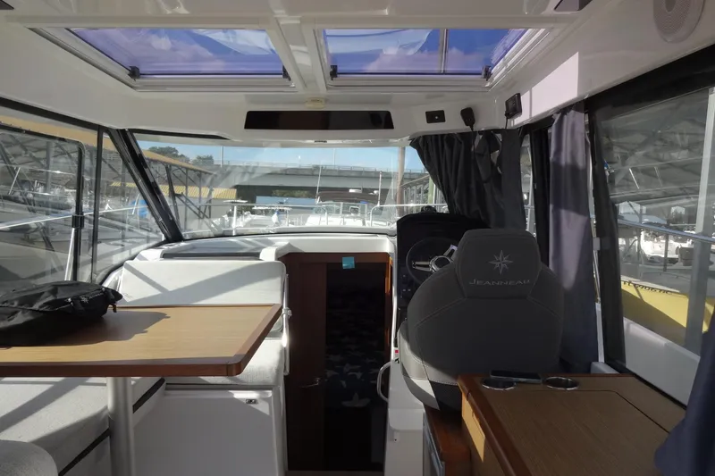 Slide: The Image of Interior of 2022 Jeanneau Merry Fisher 895 Offshore, featuring helm and seating area. - 51