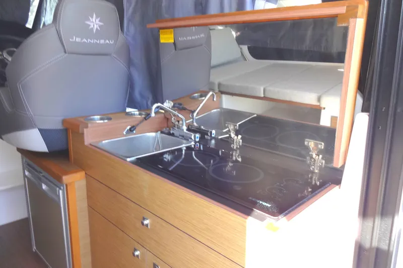 Slide: The Image of 2022 Jeanneau Merry Fisher 895 Offshore interior kitchen with sink and stove. - 54