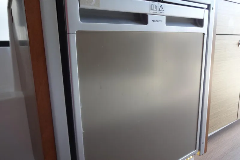 Slide: The Image of Compact Dometic fridge inside 2022 Jeanneau Merry Fisher 895 Offshore boat cabin. - 56