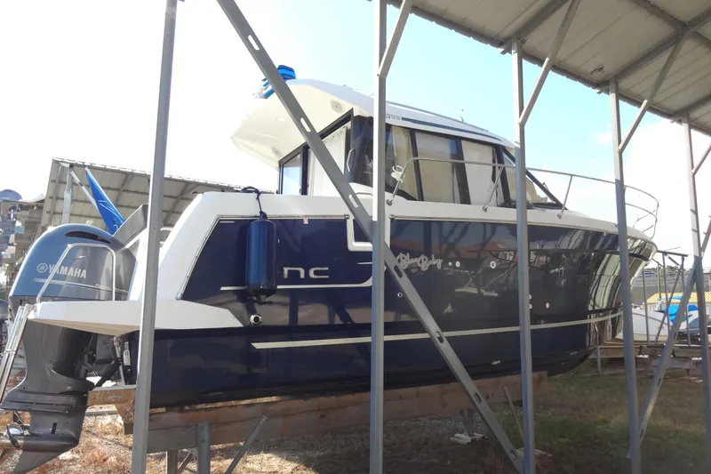 Slide: The Image of 2022 Jeanneau Merry Fisher 895 Offshore boat with Yamaha engine, docked under shelter. - 6