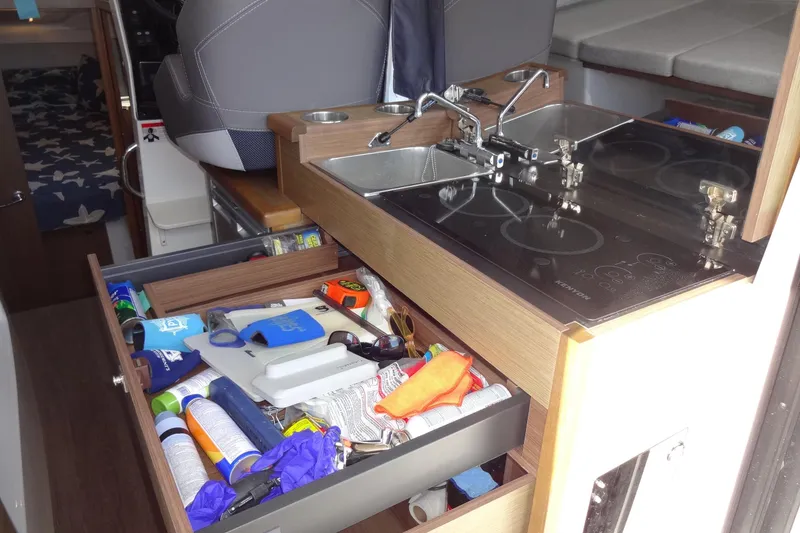 Slide: The Image of Interior of 2022 Jeanneau Merry Fisher 895 Offshore with kitchen and storage drawer. - 60