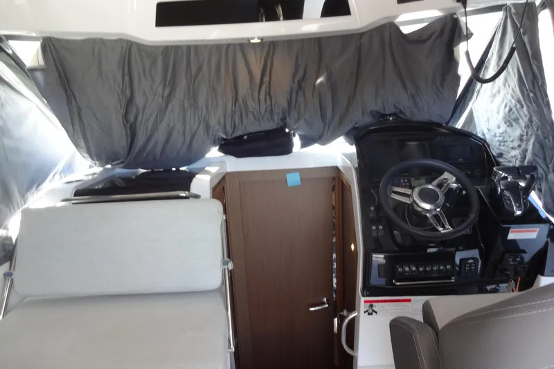 Slide: The Image of Interior of 2022 Jeanneau Merry Fisher 895 Offshore boat, featuring helm and seating area. - 62