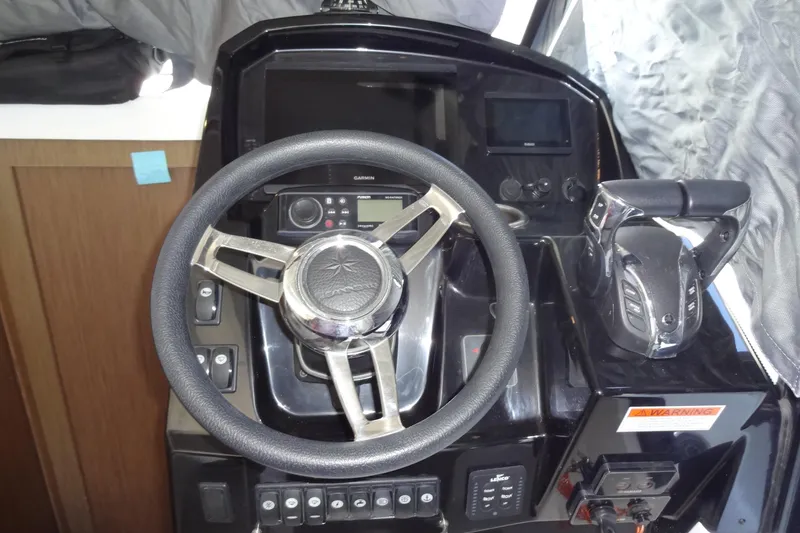 Slide: The Image of Cockpit of 2022 Jeanneau Merry Fisher 895 Offshore with steering wheel and controls. - 63