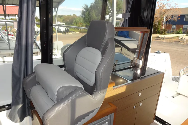Slide: The Image of 2022 Jeanneau Merry Fisher 895 Offshore interior with helm seat and kitchenette. - 65