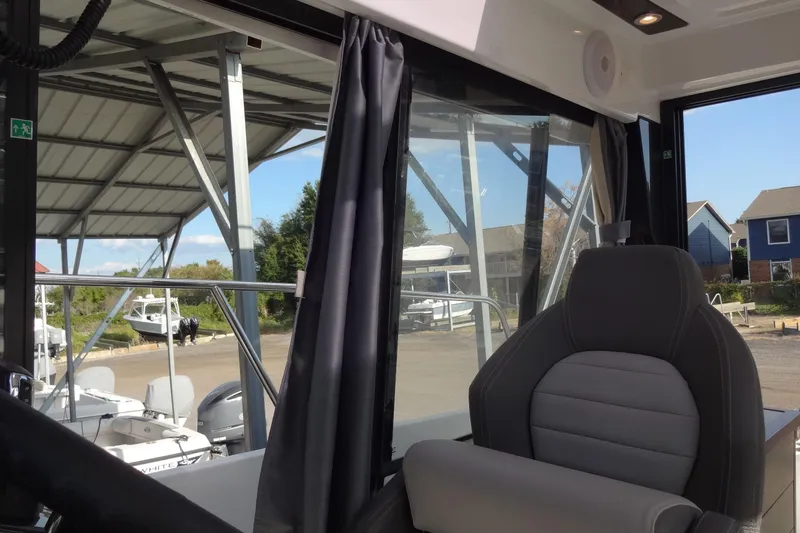 Slide: The Image of Interior view of 2022 Jeanneau Merry Fisher 895 Offshore boat with dockside background. - 66