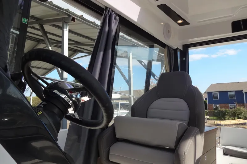 Slide: The Image of Interior of 2022 Jeanneau Merry Fisher 895 Offshore, featuring steering wheel and captain's chair. - 67
