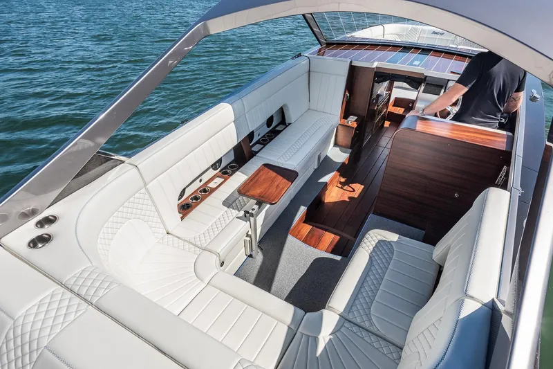 Slide: The Image of Luxurious 2023 StanCraft 390 Hammerhead boat interior with elegant white seating and wooden accents. - 4