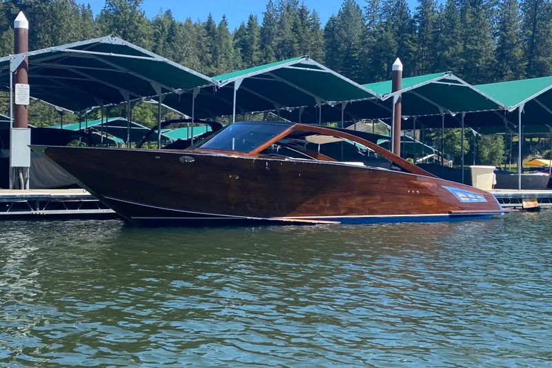 The Image of 2023 StanCraft 340 Darkside luxury boat docked on a serene lake. - 1
