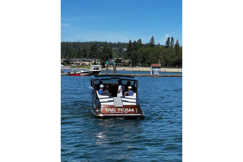 Slide: The Image of 2023 StanCraft 340 Darkside boat cruising on a lake with passengers onboard. - 4