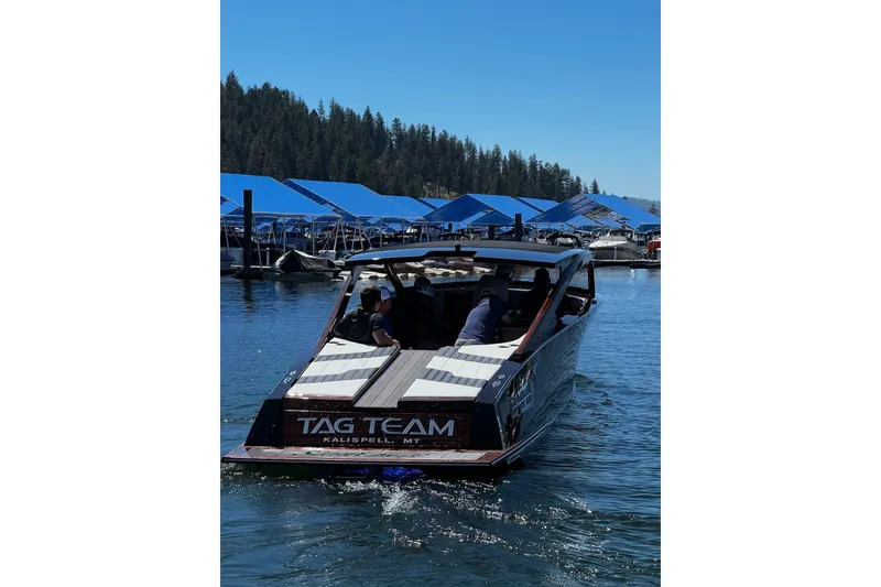 Slide: The Image of 2023 StanCraft 340 Darkside boat on a lake, Kalispell, MT, with people onboard. - 5