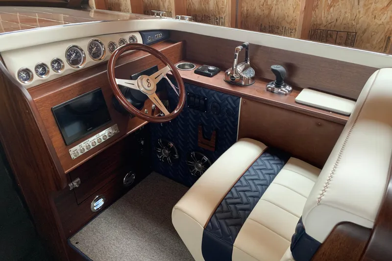 Slide: The Image of 2023 StanCraft 340 Darkside boat interior with luxurious wood and leather detailing. - 7