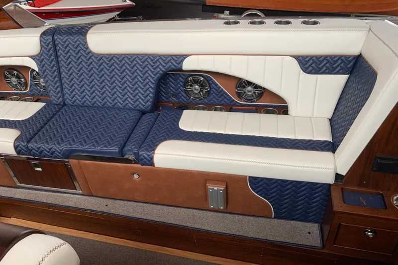 Slide: The Image of Luxurious seating in 2023 StanCraft 340 Darkside boat, featuring blue and white quilted upholstery. - 8