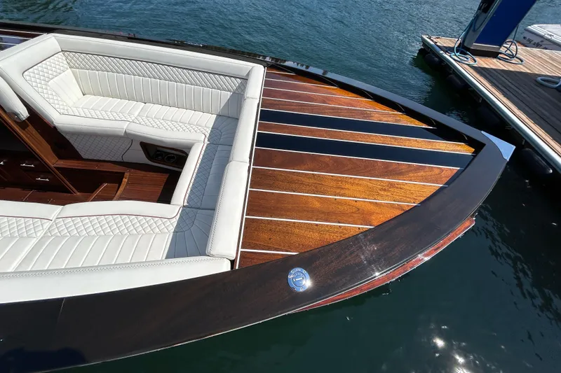 Slide: The Image of 2019 StanCraft 380 Hammerhead boat with elegant wood deck and white seating. - 4