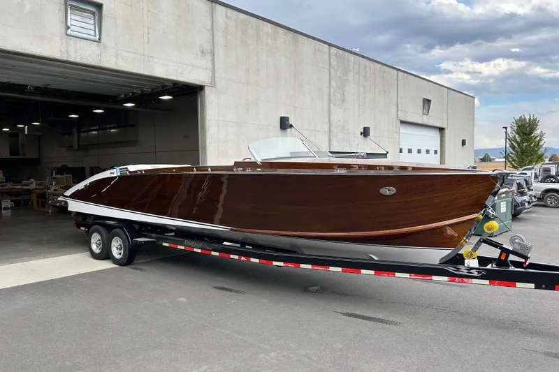 The Image of 2013 StanCraft 34 Highboy Deluxe boat on trailer outside industrial building. - 1