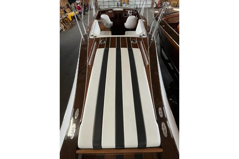 Slide: The Image of 2013 StanCraft 34 Highboy Deluxe boat with striped seating and polished wood finish. - 10