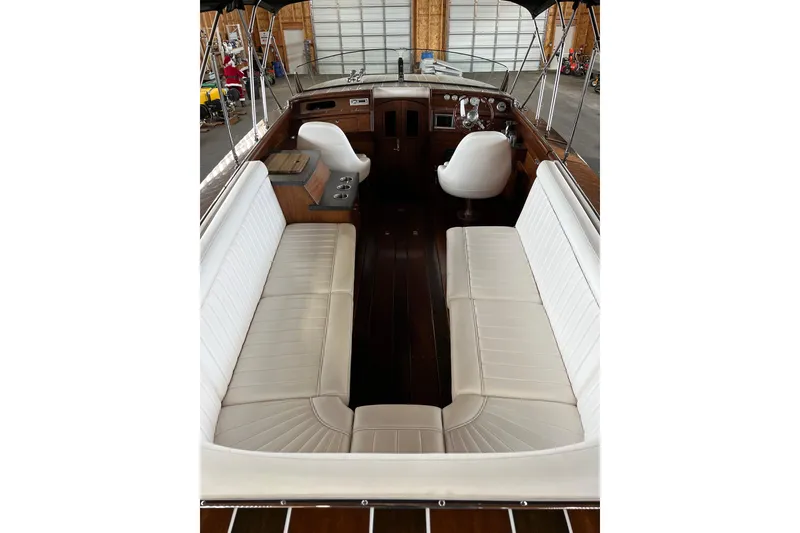 Slide: The Image of Interior of 2013 StanCraft 34 Highboy Deluxe boat with white seating and wooden accents. - 12