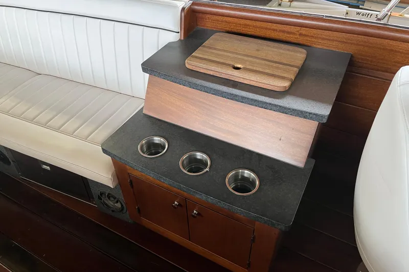Slide: The Image of Interior of 2013 StanCraft 34 Highboy Deluxe with wooden cabinetry and cup holders. - 13
