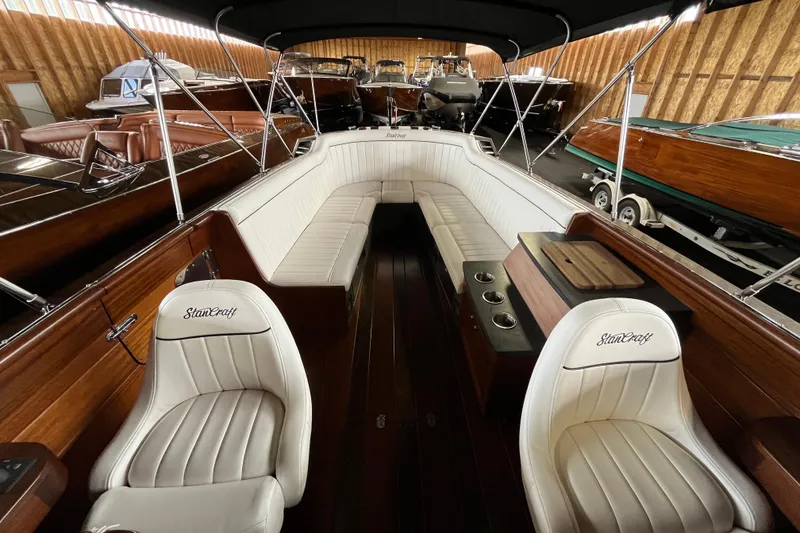 Slide: The Image of 2013 StanCraft 34 Highboy Deluxe boat interior with white leather seating and wooden accents. - 16
