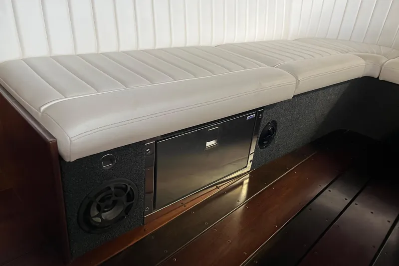 Slide: The Image of Interior of 2013 StanCraft 34 Highboy Deluxe with white seating and built-in speaker. - 18