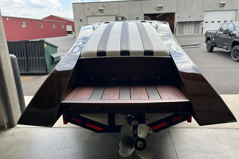 Slide: The Image of 2013 StanCraft 34 Highboy Deluxe boat, rear view in a warehouse setting. - 5