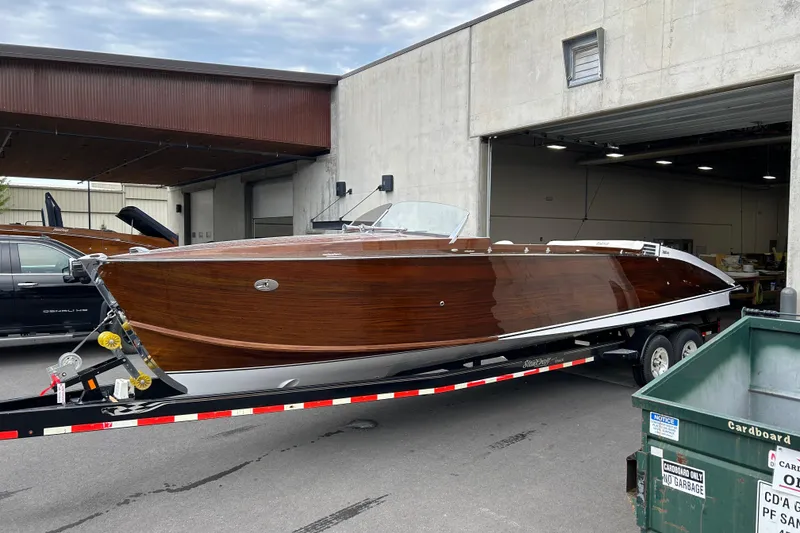 Slide: The Image of 2013 StanCraft 34 Highboy Deluxe boat on trailer outside a garage. - 7