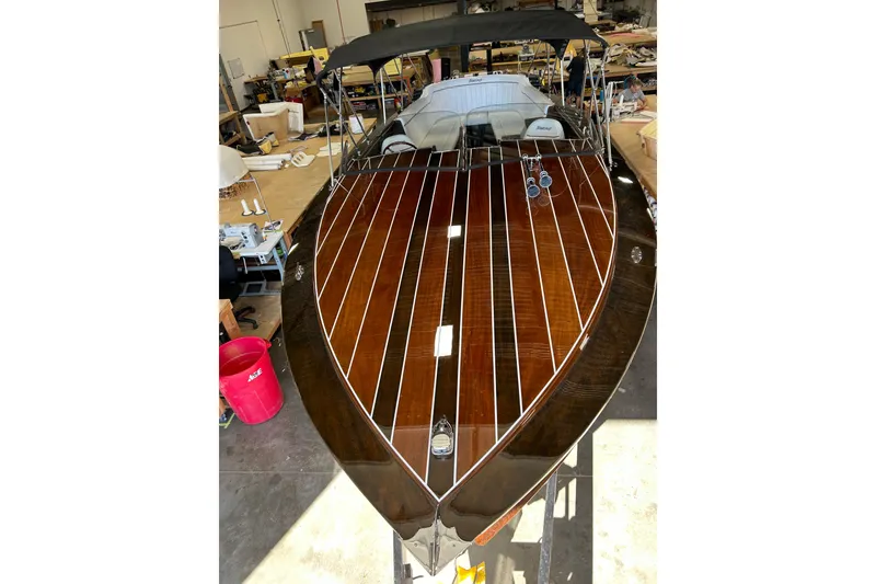 Slide: The Image of 2013 StanCraft 34 Highboy Deluxe boat with polished wooden deck in workshop setting. - 9