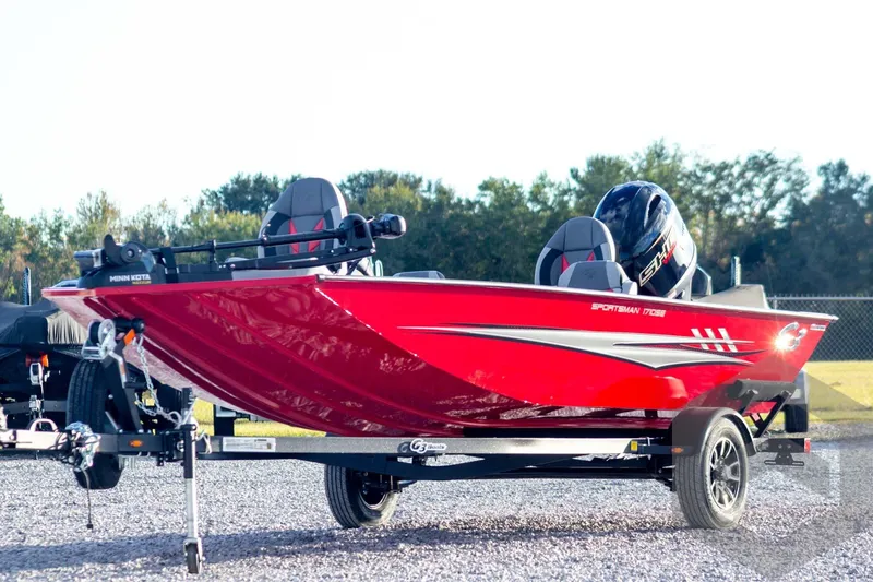 The Image of 2026 G3 Sportsman 1710 SE boat, vibrant red, on trailer, outdoors. - 1