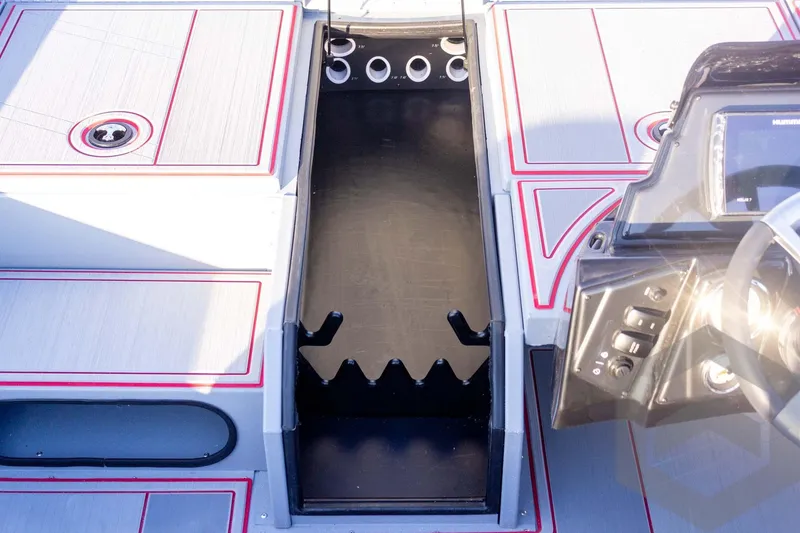 Slide: The Image of 2026 G3 Sportsman 1710 SE boat interior with rod holders and control panel. - 26