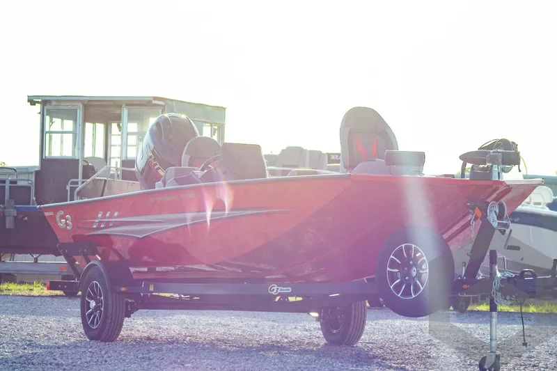 Slide: The Image of 2026 G3 Sportsman 1710 SE boat in sunlight, parked on gravel. - 3