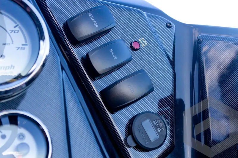 Slide: The Image of Dashboard controls of 2026 G3 Sportsman 1710 SE boat with switches and gauges. - 37
