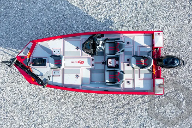 Slide: The Image of 2026 G3 Sportsman 1710 SE boat, aerial view, red and gray design, gravel background. - 50
