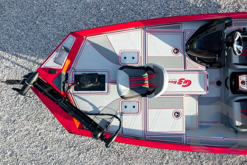 Slide: The Image of 2026 G3 Sportsman 1710 SE boat, top view, red and gray design, gravel background. - 51