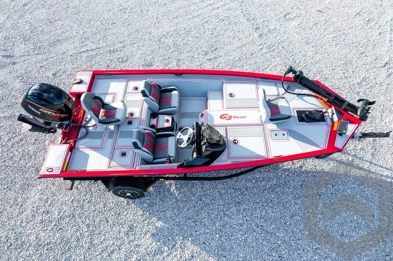 Slide: The Image of 2026 G3 Sportsman 1710 SE boat, aerial view, red and gray design, gravel background. - 58