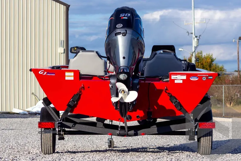 Slide: The Image of 2026 G3 Sportsman 1710 SE boat with outboard motor, parked on gravel. - 7