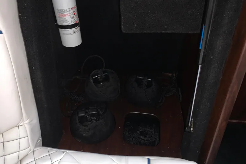 Slide: The Image of Interior of 2017 StanCraft 24 Highboy Surf boat with fire extinguisher and storage bags. - 11