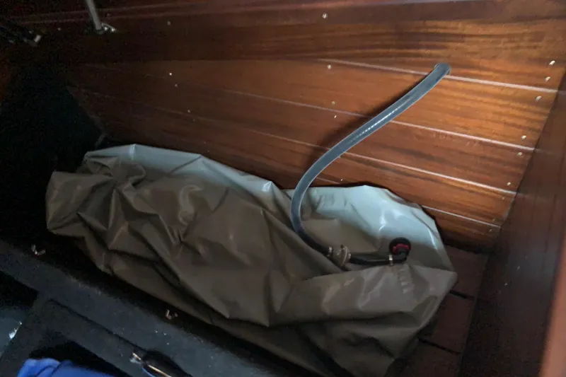 Slide: The Image of Interior of a 2017 StanCraft 24 Highboy Surf boat with storage compartment. - 17