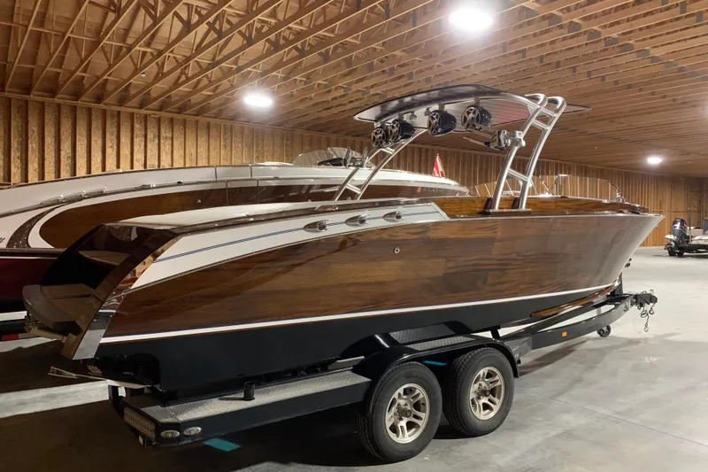 Slide: The Image of 2017 StanCraft 24 Highboy Surf boat in wooden interior storage facility. - 2