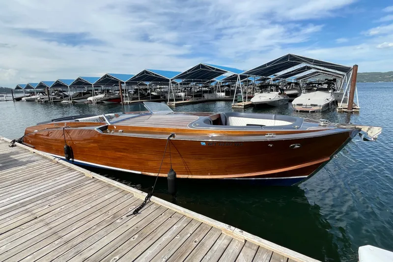 The Image of 2013 StanCraft 360 Rivelle wooden boat docked at marina under blue sky. - 1