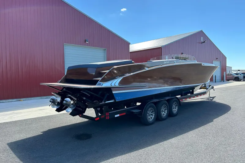 Slide: The Image of 2013 StanCraft 360 Rivelle boat on trailer near red warehouse buildings. - 10