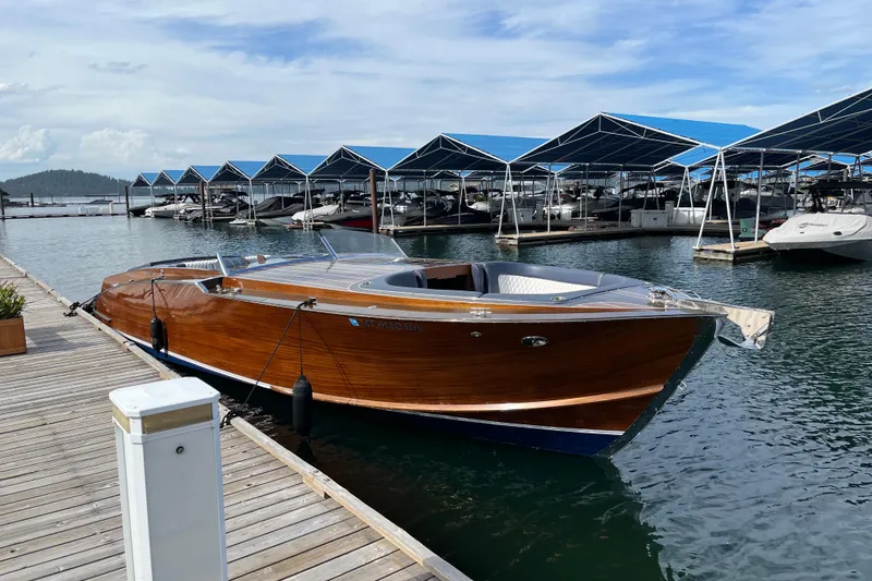 Slide: The Image of 2013 StanCraft 360 Rivelle boat docked at marina with covered slips. - 2