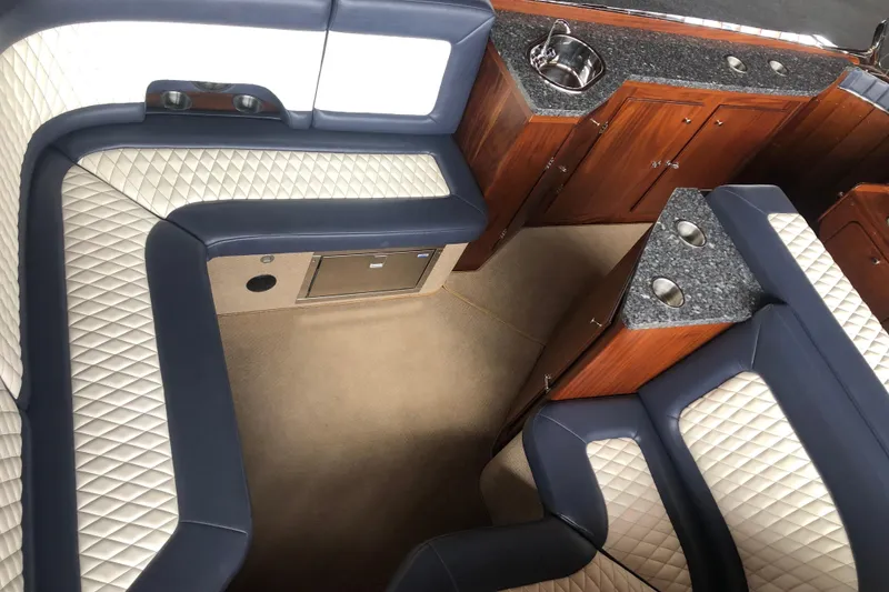 Slide: The Image of Luxurious interior of a 2013 StanCraft 360 Rivelle boat with quilted seating and wood cabinetry. - 21