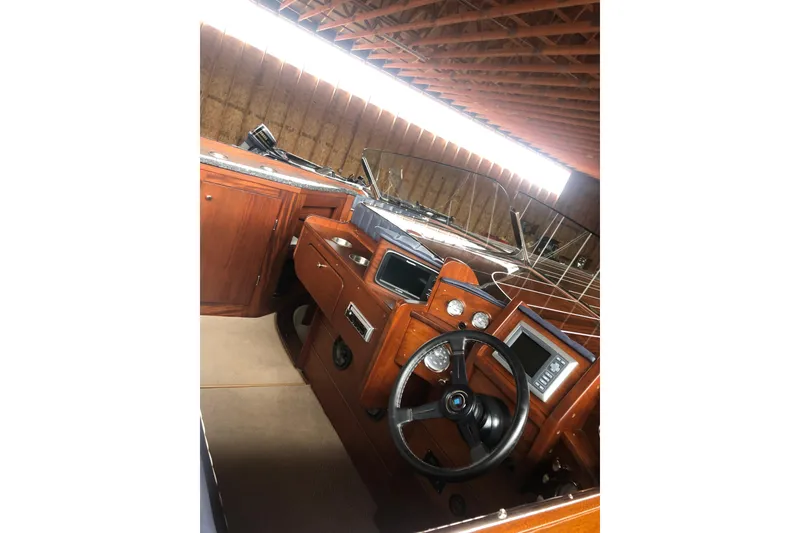 Slide: The Image of 2013 StanCraft 360 Rivelle boat interior with wooden dashboard and steering wheel. - 23