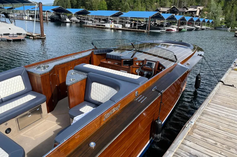Slide: The Image of Luxurious 2013 StanCraft 360 Rivelle boat docked, featuring elegant wood finish and plush seating. - 5